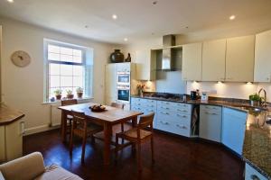 a kitchen with a wooden table and a dining room at Albion House in Deal