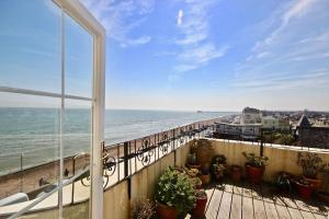 a balcony with a view of the beach and the ocean at Albion House in Deal