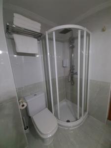 a white bathroom with a shower and a toilet at APARTAMENTO CORTEGADA in Vilagarcia de Arousa