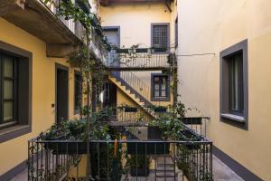 a building with stairs and plants on it at Maison Borella in Milan