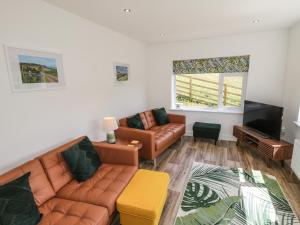 a living room with a couch and a television at Foulsyke Farm Bungalow in Saltburn-by-the-Sea