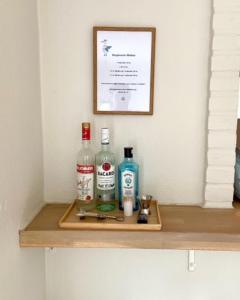 a shelf with two bottles of alcohol on it at Havgassens in Sæby