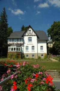 a large white house with flowers in front of it at Ferienwohnung in Villa in Bad Elster