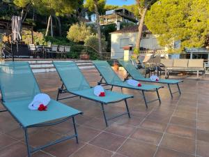 a row of blue chairs with hats on them at Villa Bella in Castelldefels