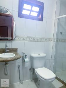 a white bathroom with a toilet and a sink at Spazio Martinelli in Santa Teresa