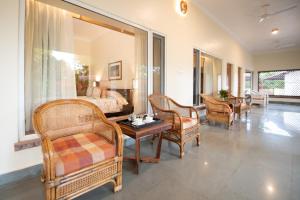 a living room with a bed and chairs and a table at Fateh's Retreat, Homestay in Sawāi Mādhopur