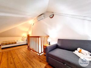 a living room with a couch and a bed at Cumin - Studio duplex avec accès piscine à St-Gilles in Saint-Gilles les Bains