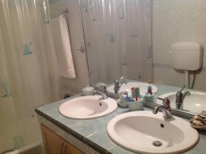 a bathroom with two sinks and a shower at Villa Kallia's in Vília
