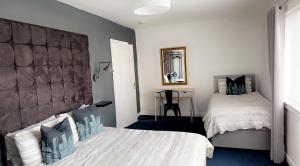 a bedroom with two beds and a table in it at Crown street getaway in Ayr