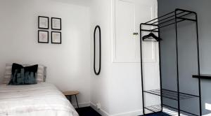 a bedroom with a black ladder next to a bed at Crown street getaway in Ayr