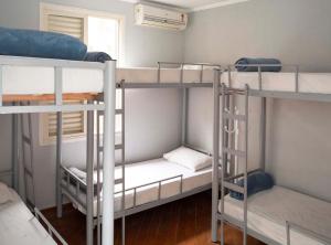 a room with three bunk beds in a room at Casa Ecotrips Barra Funda - Hostel in Sao Paulo