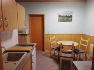 a kitchen with a table and chairs and a table and a table at Apartment in Ilmenau 42915 in Ilmenau