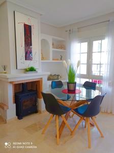 a living room with a table and chairs and a fireplace at TOWNHOUSE 1 minute walk to Villamartin plaza in Villamartin +14 photos