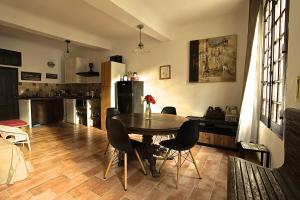 a kitchen and dining room with a table and chairs at La Bonne Etoile - The Good Star in Moustiers-Sainte-Marie