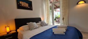 a bedroom with a blue and white bed with a window at Apartment Nikola in Jelsa +55 photos