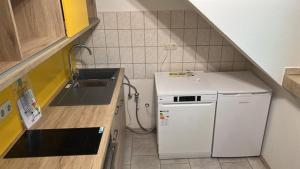 una pequeña cocina con fregadero y lavavajillas en Schone Monteure Wohnung in Duisburg Meiderich 47137 en Duisburg