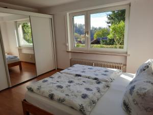a bedroom with a bed in front of a window at FeWo mit Terrasse für 4-5 Personen mit Schwimmbad + Sauna in Bad Grund +16 photos
