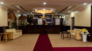 a lobby with couches and a red carpet at BOONMAX Hotel in Dubai