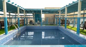 a swimming pool in the middle of a building at BOONMAX Hotel in Dubai