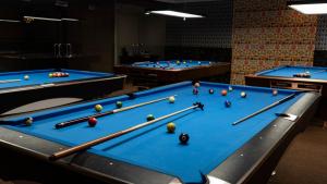 three billiard tables with balls on top of them at BOONMAX Hotel in Dubai