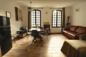 a living room with a table and a couch at La Bonne Etoile - The Good Star in Moustiers-Sainte-Marie