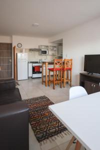 a kitchen and living room with a table and chairs at GARAY 29- Depto un dormitorio in Santa Fe