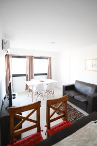 a living room with a couch and a table at GARAY 29- Depto un dormitorio in Santa Fe