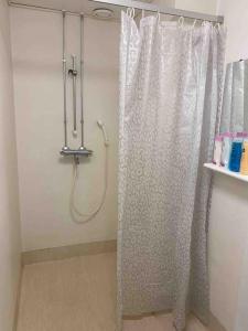 a shower with a shower curtain in a bathroom at Style 2BR appartment in Tornio city in Tornio