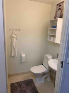 a bathroom with a white toilet and a sink at Style 2BR appartment in Tornio city in Tornio