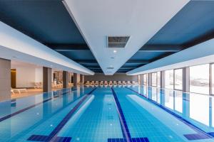 a large swimming pool with a blue ceiling at Hotel Crni Vrh in Divčibare