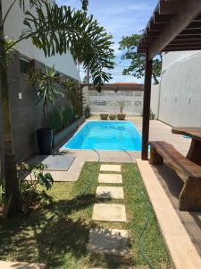 a swimming pool in the backyard of a house at Casa de Praia Tamandare in Tamandaré