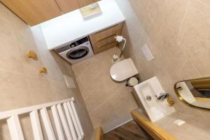 a small bathroom with a toilet and a sink at SEA SALT home - Karkle - by Hello Sea homes in Karklė