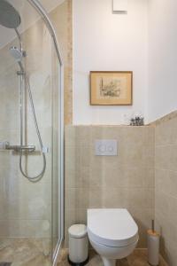 a bathroom with a toilet and a glass shower at SEA SALT home - Karkle - by Hello Sea homes in Karklė