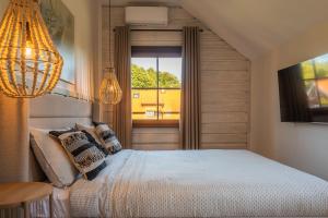 a bedroom with a bed and a large window at SEA SALT home - Karkle - by Hello Sea homes in Karklė