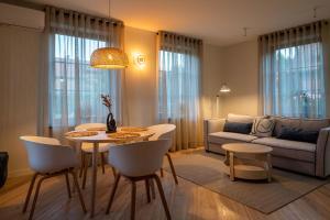 a living room with a table and chairs and a couch at SEA SALT home - Karkle - by Hello Sea homes in Karklė