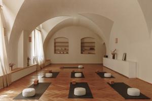 a large room with a bunch of yoga mats in it at Parkhotel Mondschein, a Member of Design Hotels in Bolzano