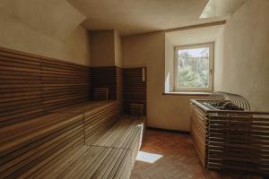 an empty sauna with a window in a room at Parkhotel Mondschein, a Member of Design Hotels in Bolzano