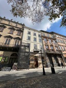 a large white building on a city street at Vysoka Khata 5 in Lviv