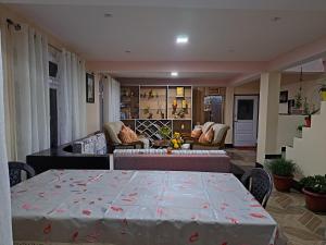 a living room with a table and a couch at Yuma Heem Homestay in Darjeeling