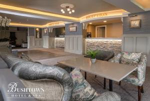 a lobby with couches and a table and a bar at Bushtown Hotel & Spa in Coleraine