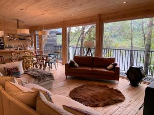 a living room with couches and a dining room and a kitchen at CASA LOICA in Chonchi