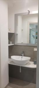 a bathroom with a white sink and a mirror at Faber B&B - Riserva Naturale Zompo lo Schioppo in Morino