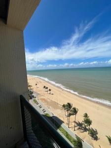 a view of the beach from the balcony of a condo at FLAT COSTA MAR in Recife