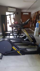 a gym with a treadmill in a room at FLAT COSTA MAR in Recife