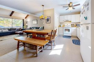 a kitchen and living room with a wooden table and chairs at Camelback 69 in Tannersville