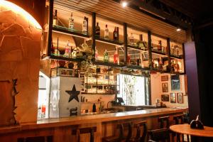 a bar in a restaurant with a refrigerator at ÔVibe Party Hostel in Belém