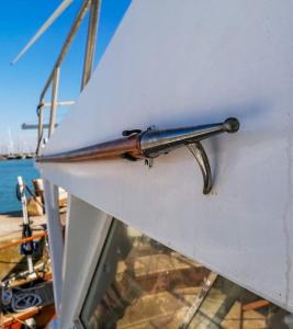 a metal gun on the side of a boat at Salvador BAHIA Boat and Breakfast in Lido di Ostia