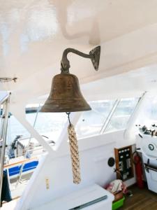 a bell hanging from the ceiling of a boat at Salvador BAHIA Boat and Breakfast in Lido di Ostia