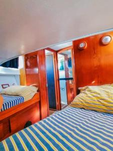 a room with two beds on a boat at Salvador BAHIA Boat and Breakfast in Lido di Ostia