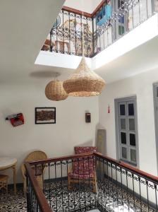 a room with a staircase with baskets hanging from the ceiling at Vallparadis Pension Familiar" FIRDAUS" in Chefchaouen